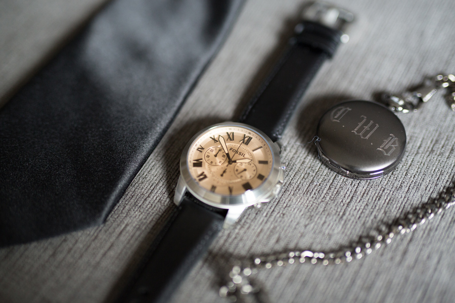 a tie, watch and pocket watch with initials engraved on it