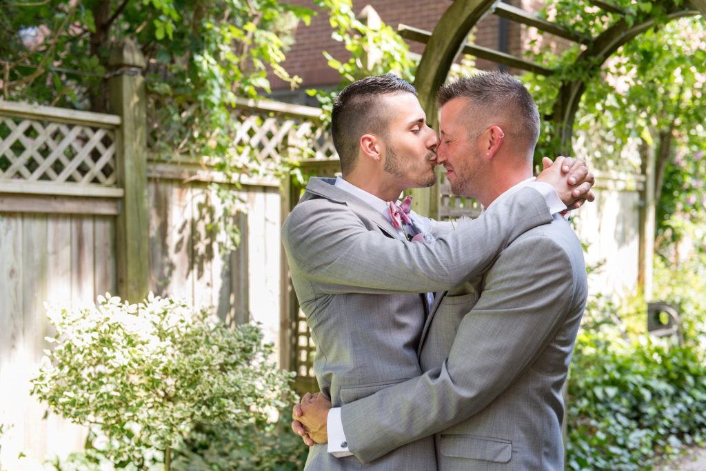 a man kisses his husband on the nose