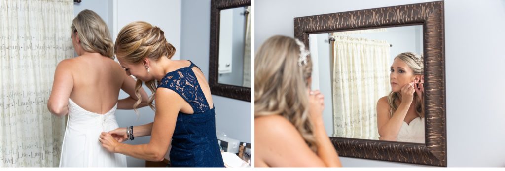 a bride puts her earrings in while looking in a mirror at her Grand Bend wedding