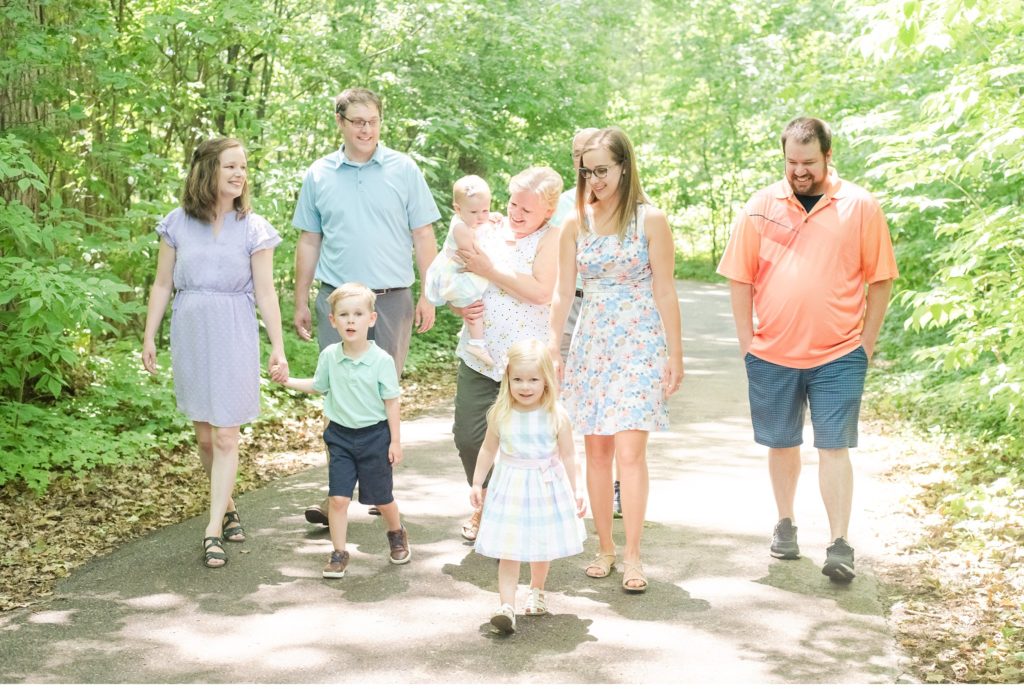 a family walking through springbank park during family photos