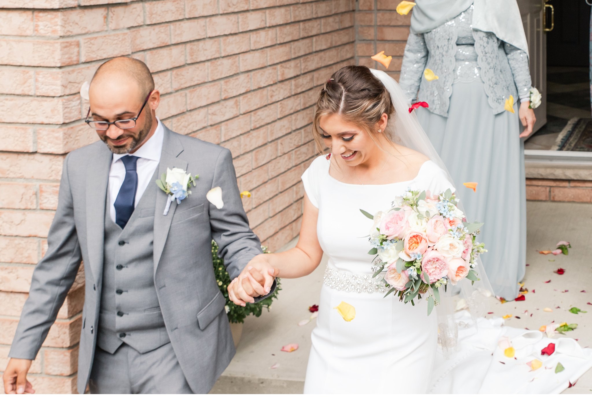 bride and groom walk together on their wedding day by london ontario wedding photographer life is beautiful photography