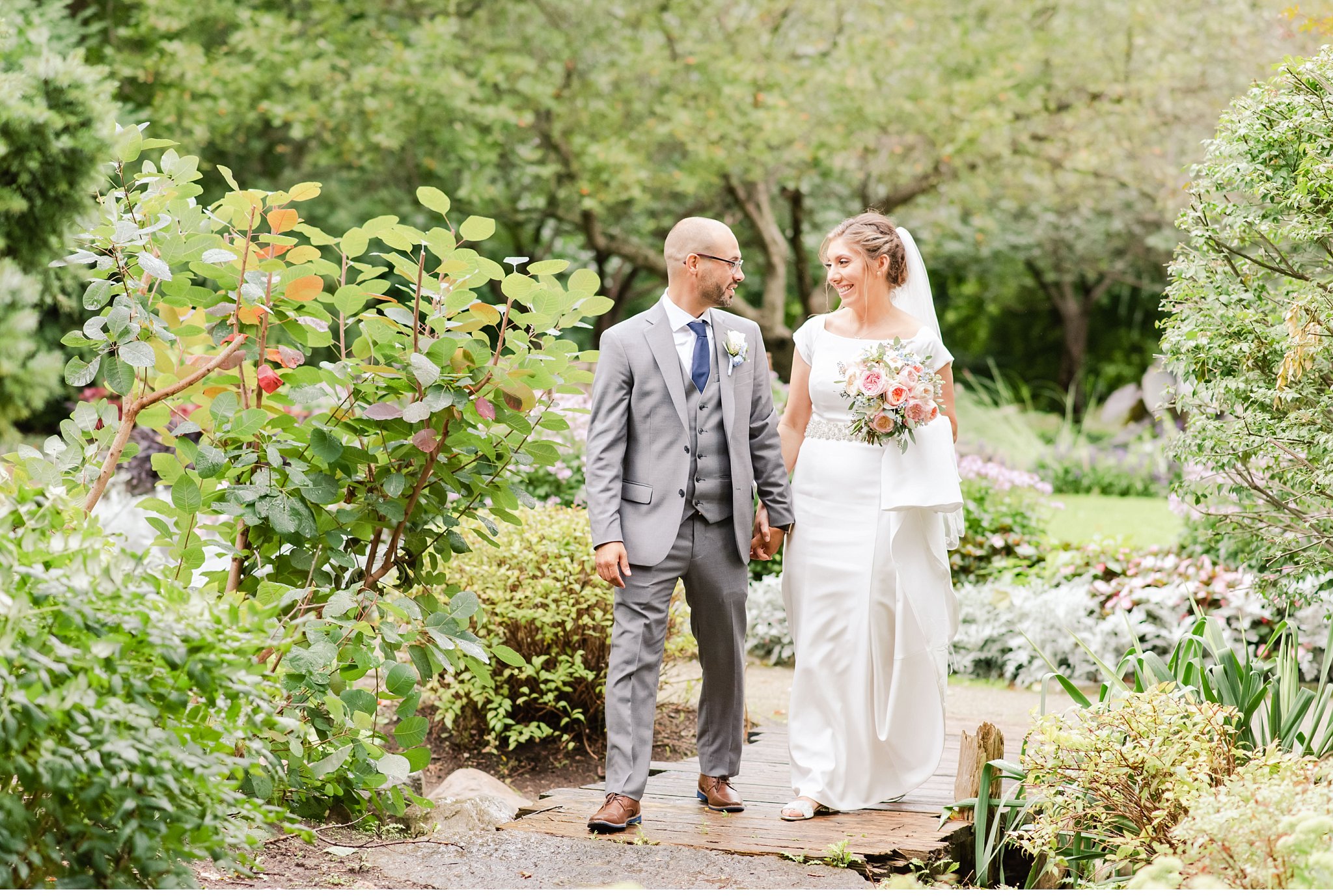 bride and groom walk together in ivey park by london ontario wedding photographer life is beautiful photography
