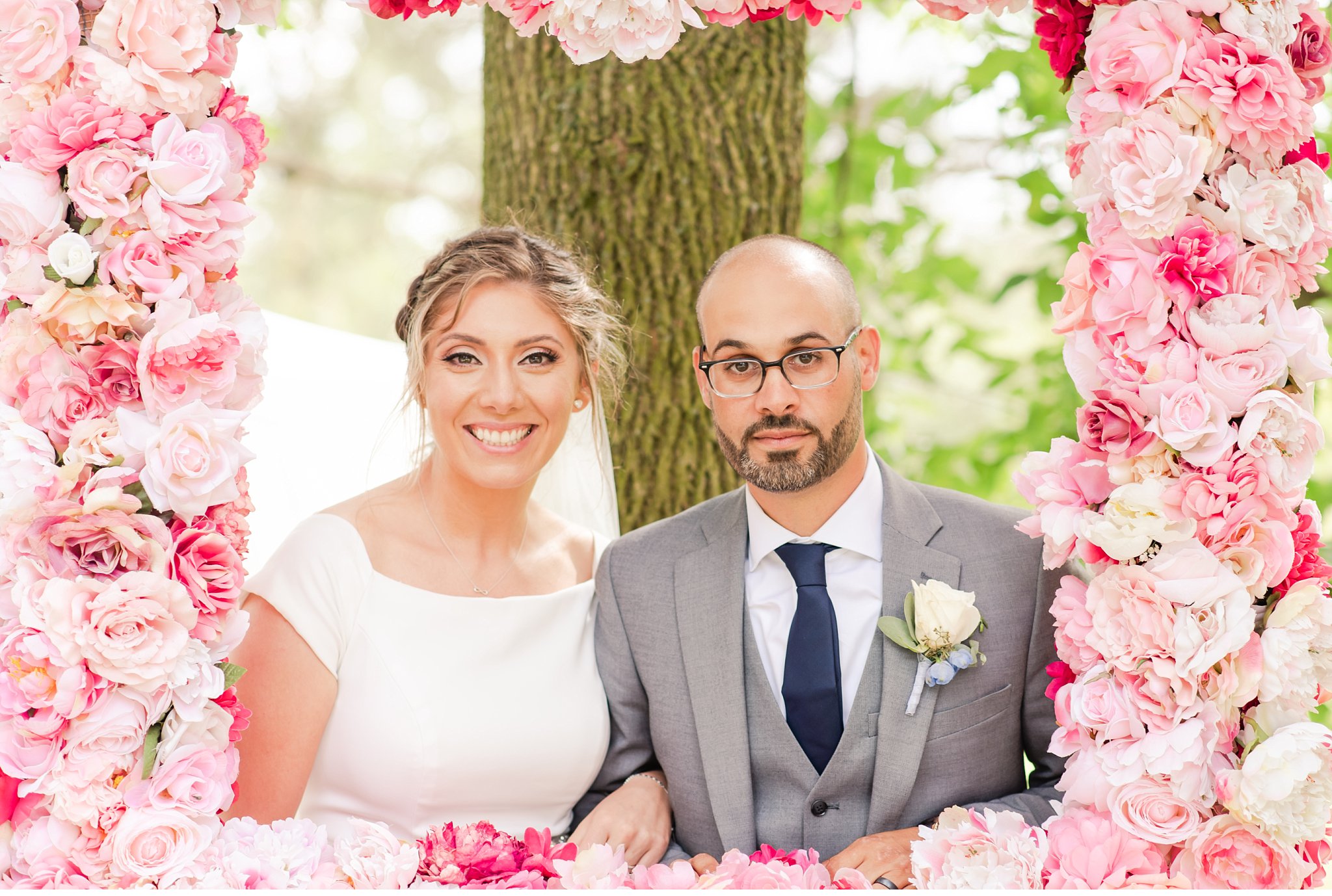 bride and groom with a floral photo frame