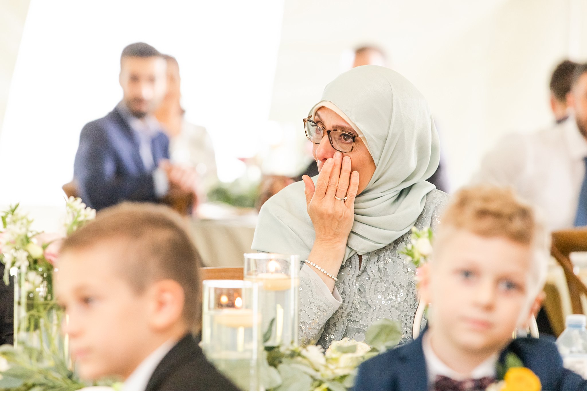 wedding reception candid of mother of bride crying by london ontario wedding photographer life is beautiful photography