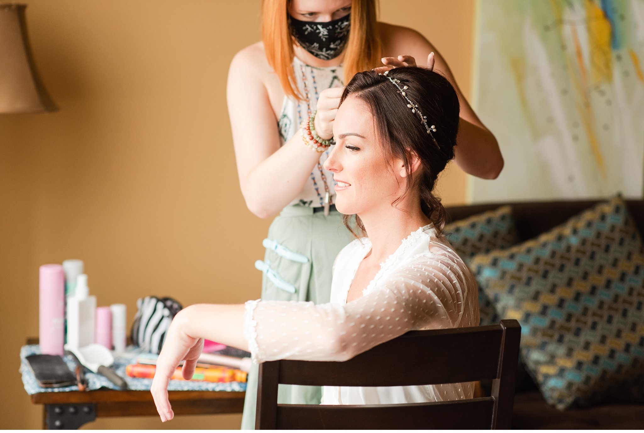 bride getting her hair done on her wedding day