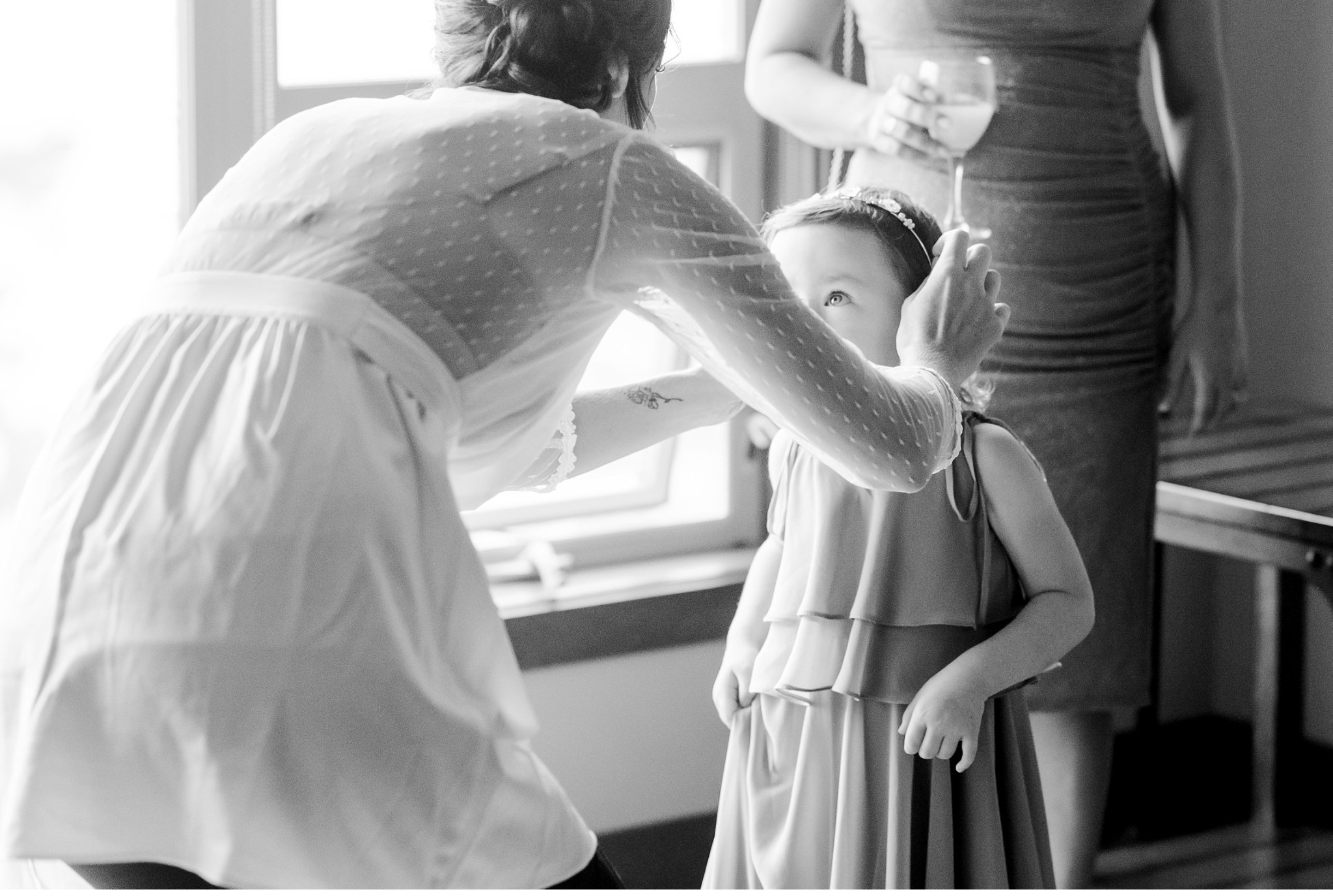 bride putting a hair piece on her daughter