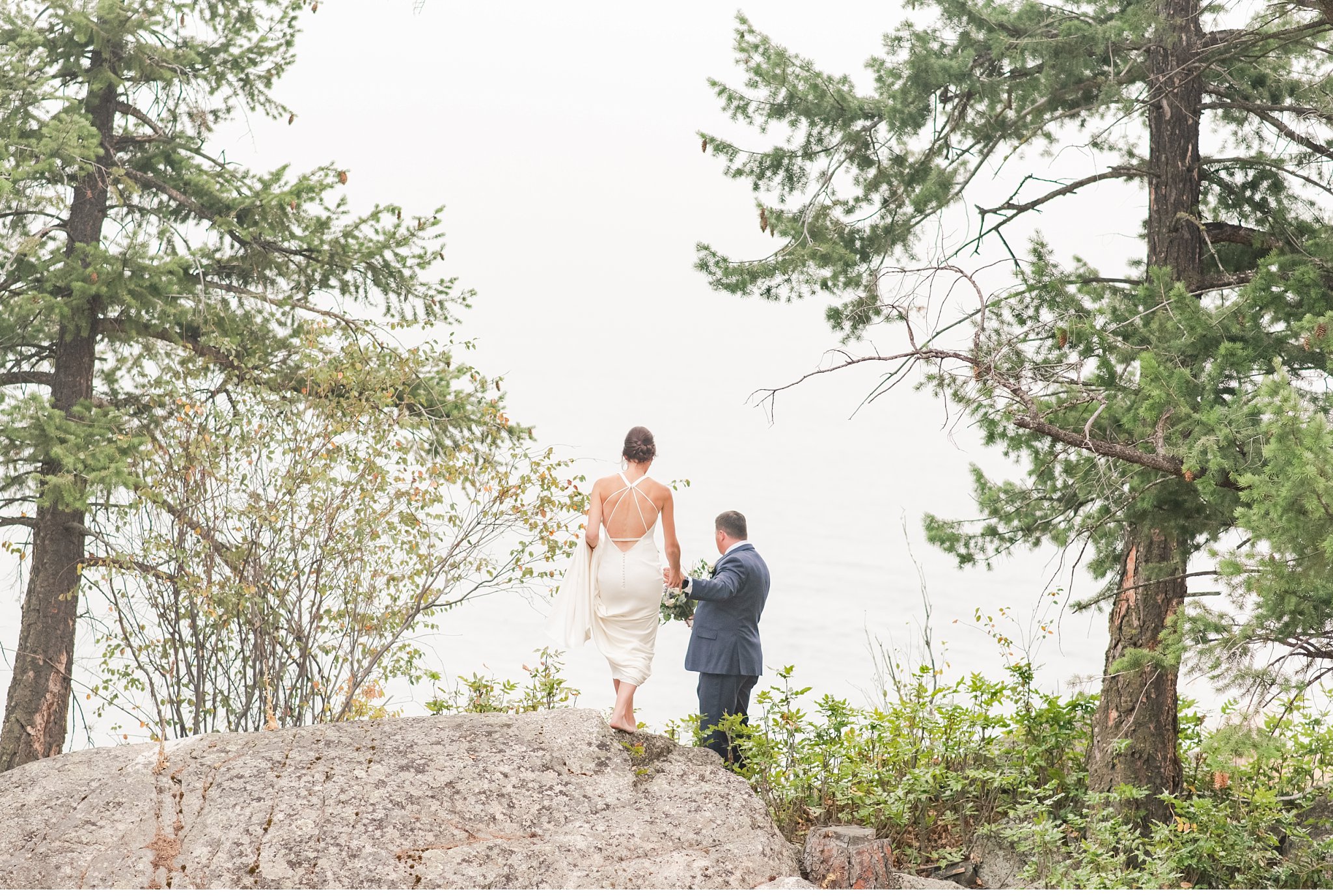 bride and groom pose together on a mountain in kelowna, british columbia