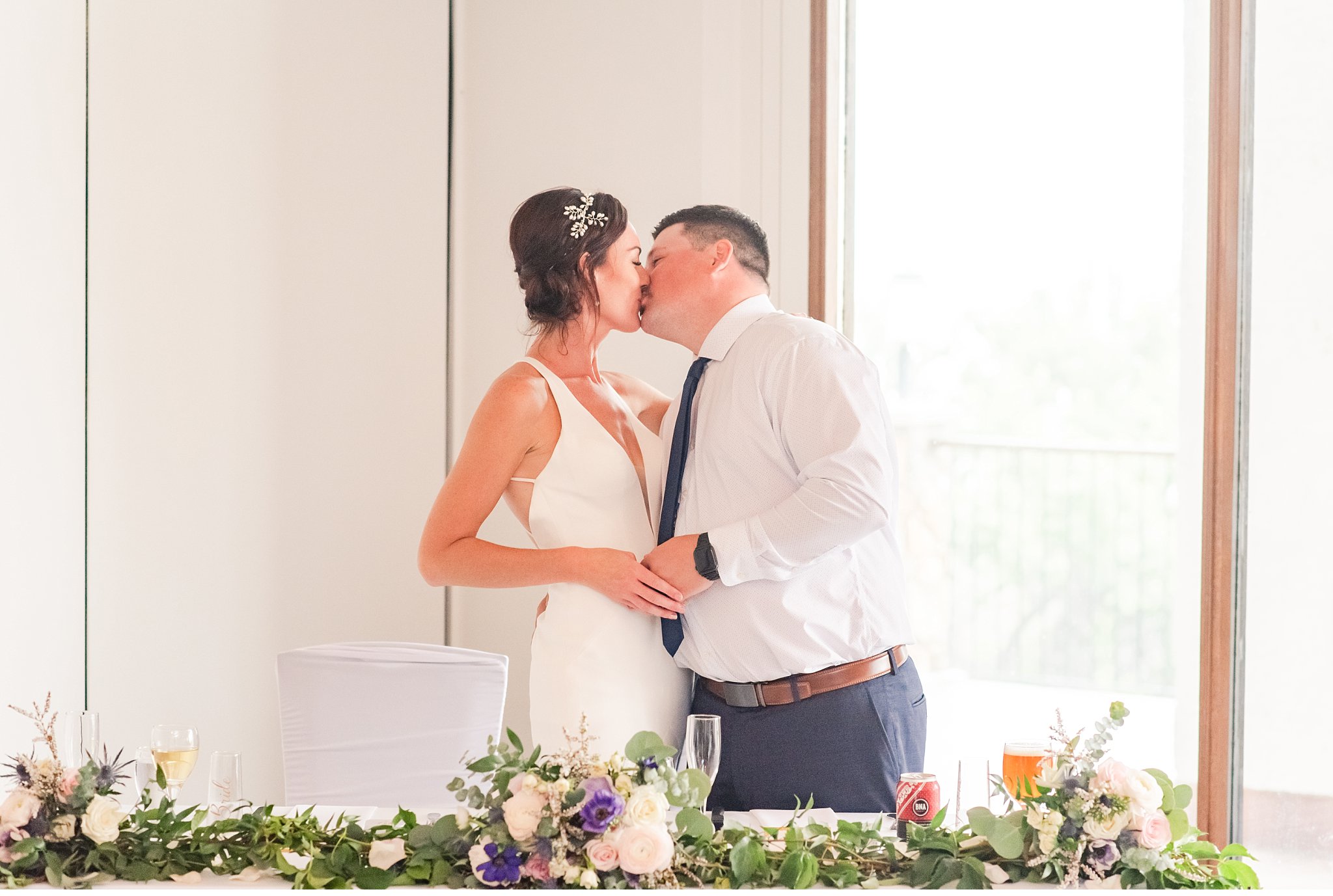 bride and groom kiss during the wedding reception