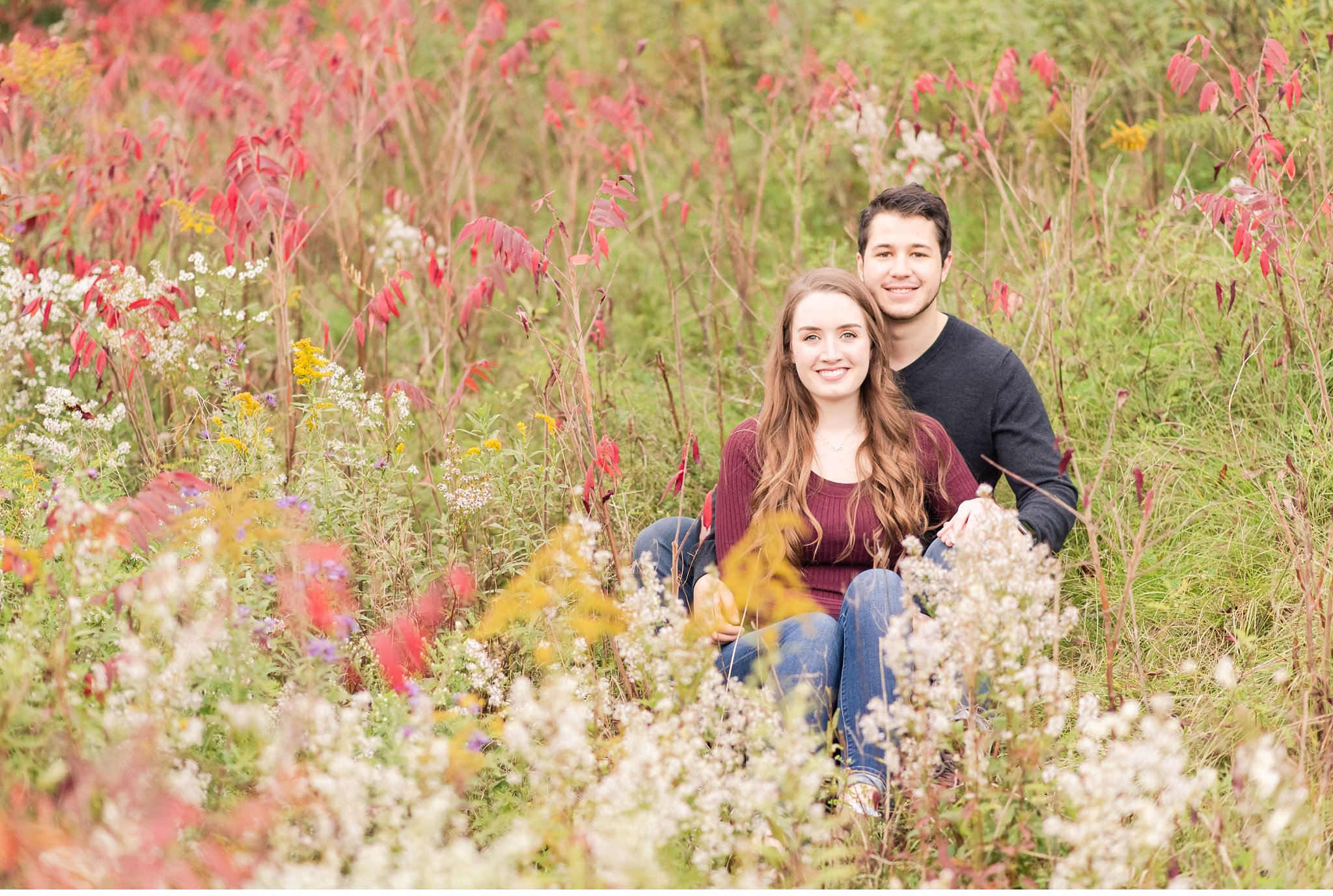 engaged couple in wildflowers at fanshawe conservation area during their engagement session