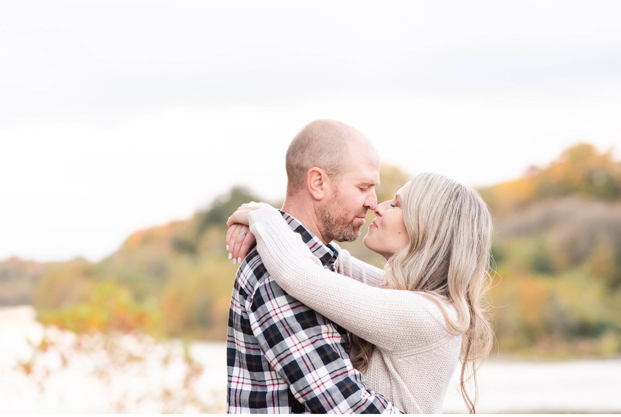 a couple kisses in springbank park in the fall