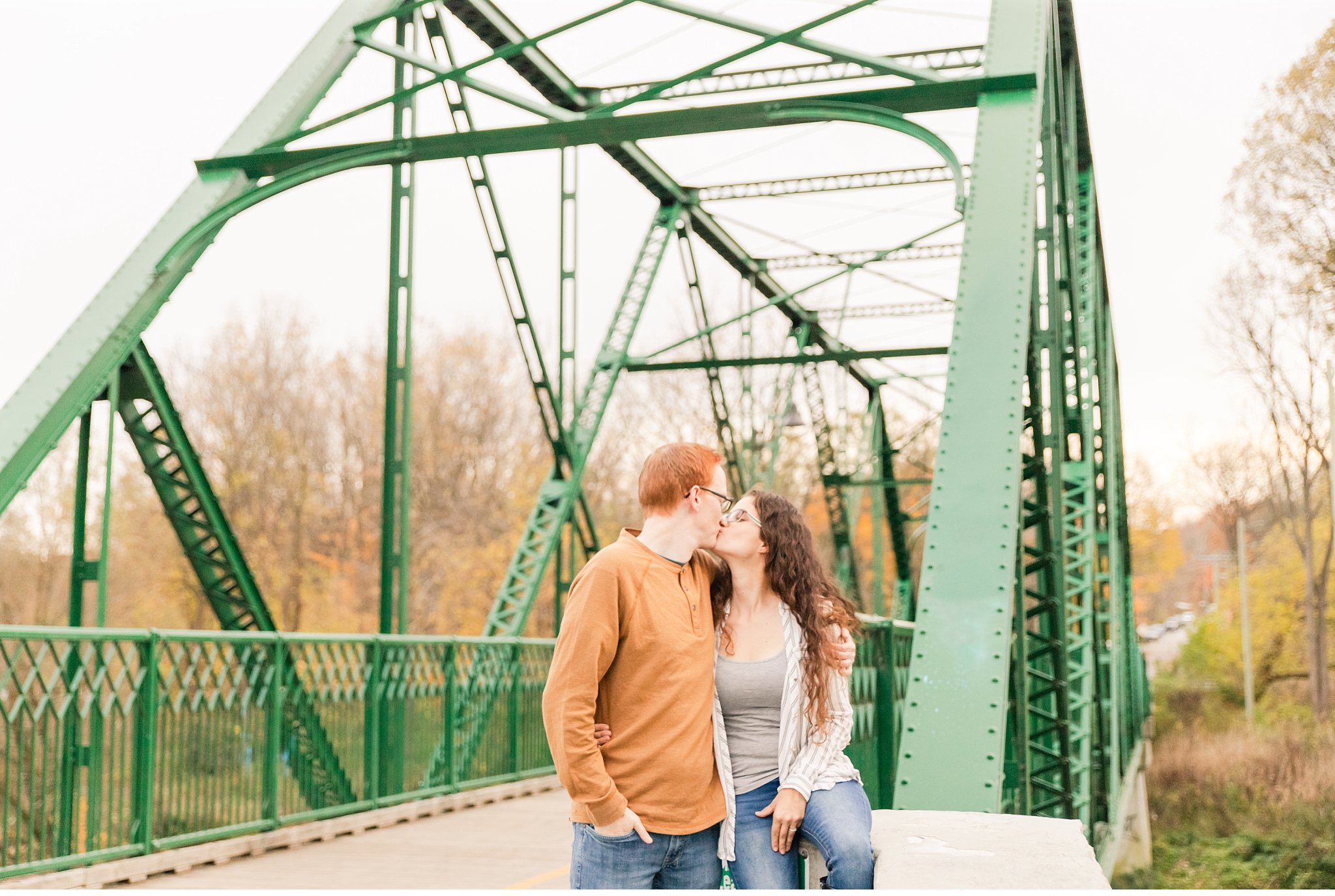 A couple kisses during their fall engagement session in London Ontario