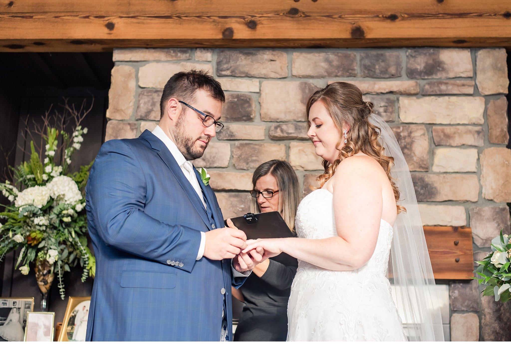 groom places ring on bride's finger during their wedding ceremony