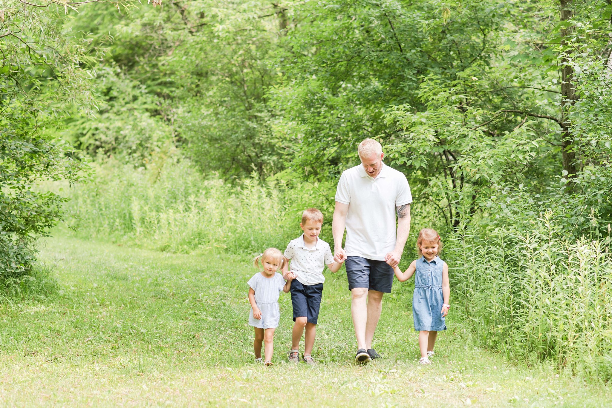 family photos in london ontario; dad walks with his kids