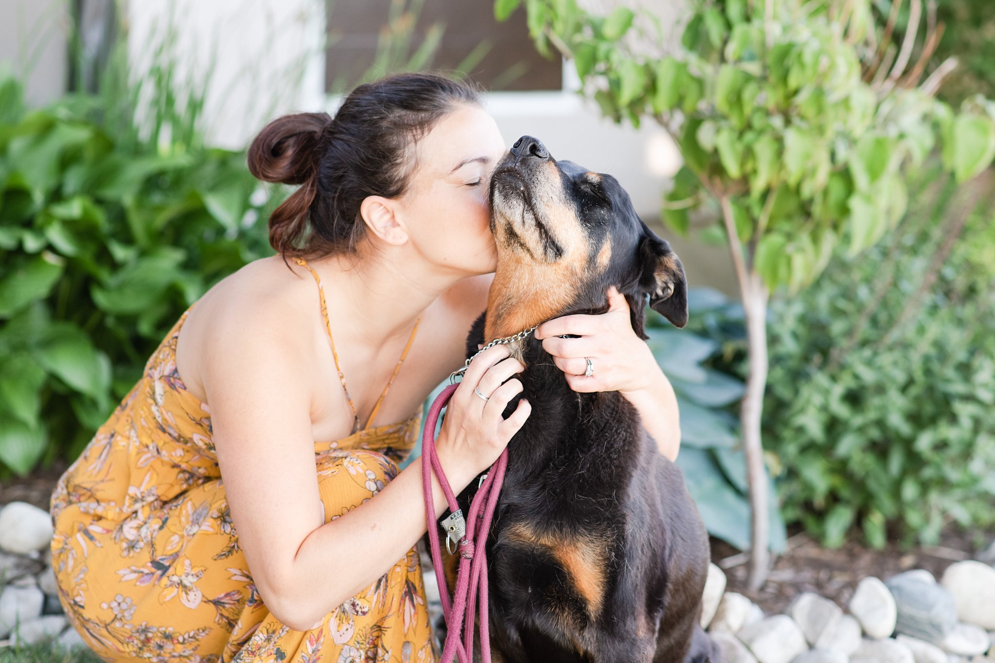 family photos in london ontario; woman kisses her dog