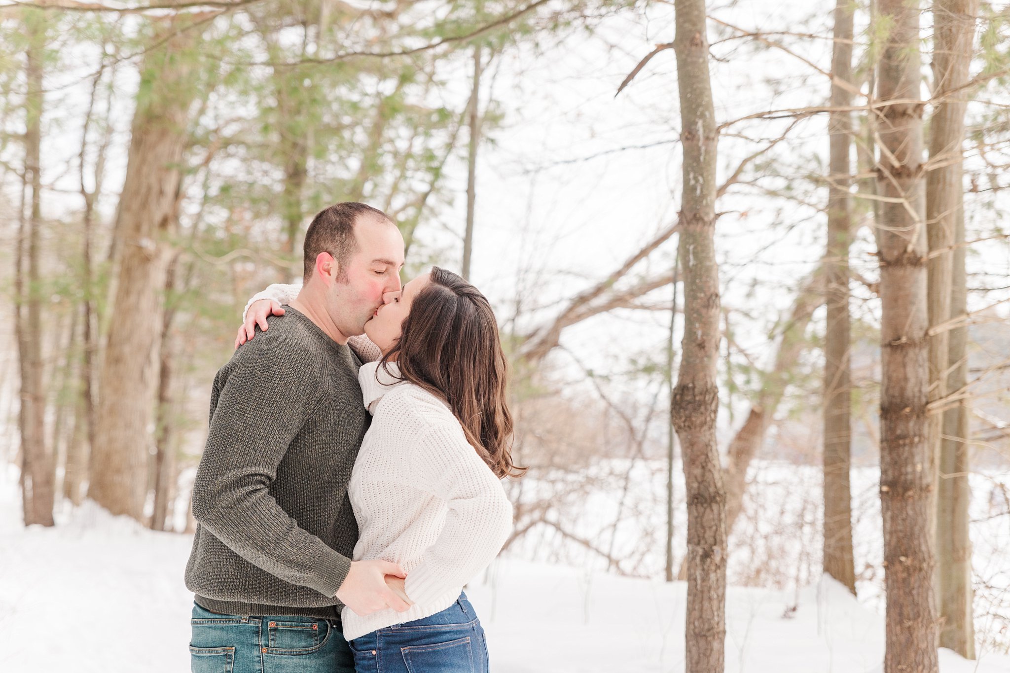 a couple kisses at mill pond in dorchester during their engagement session