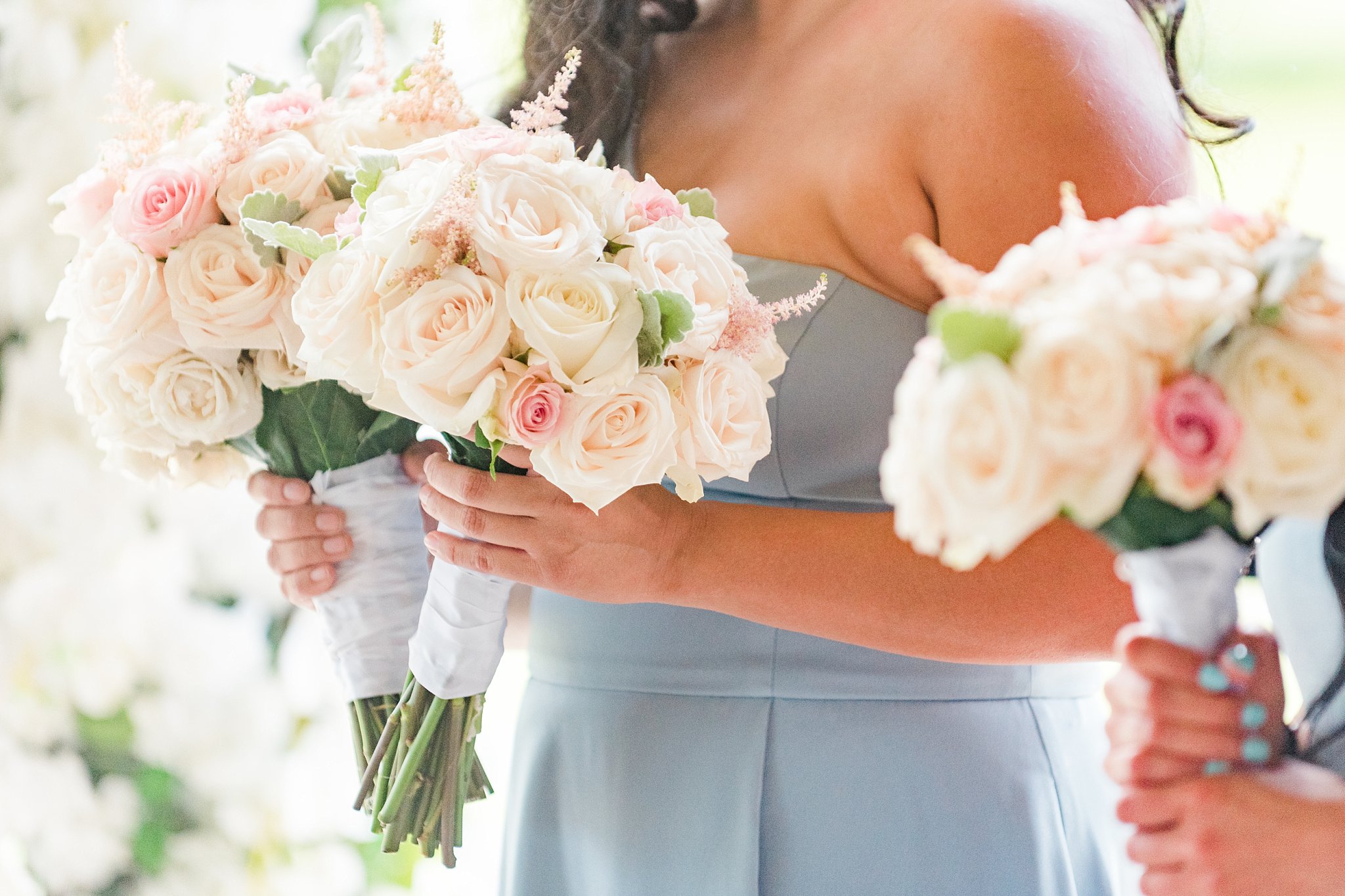 a bridesmaid holds two bouquets