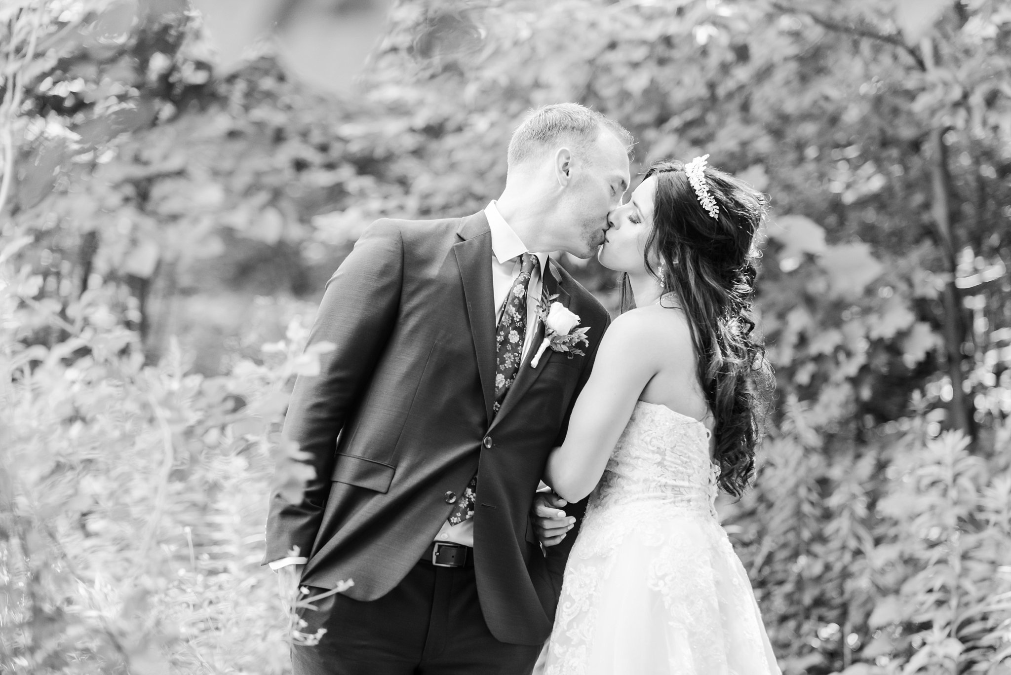 a black and white photo of a bride and groom kissing  kelowna wedding photographer