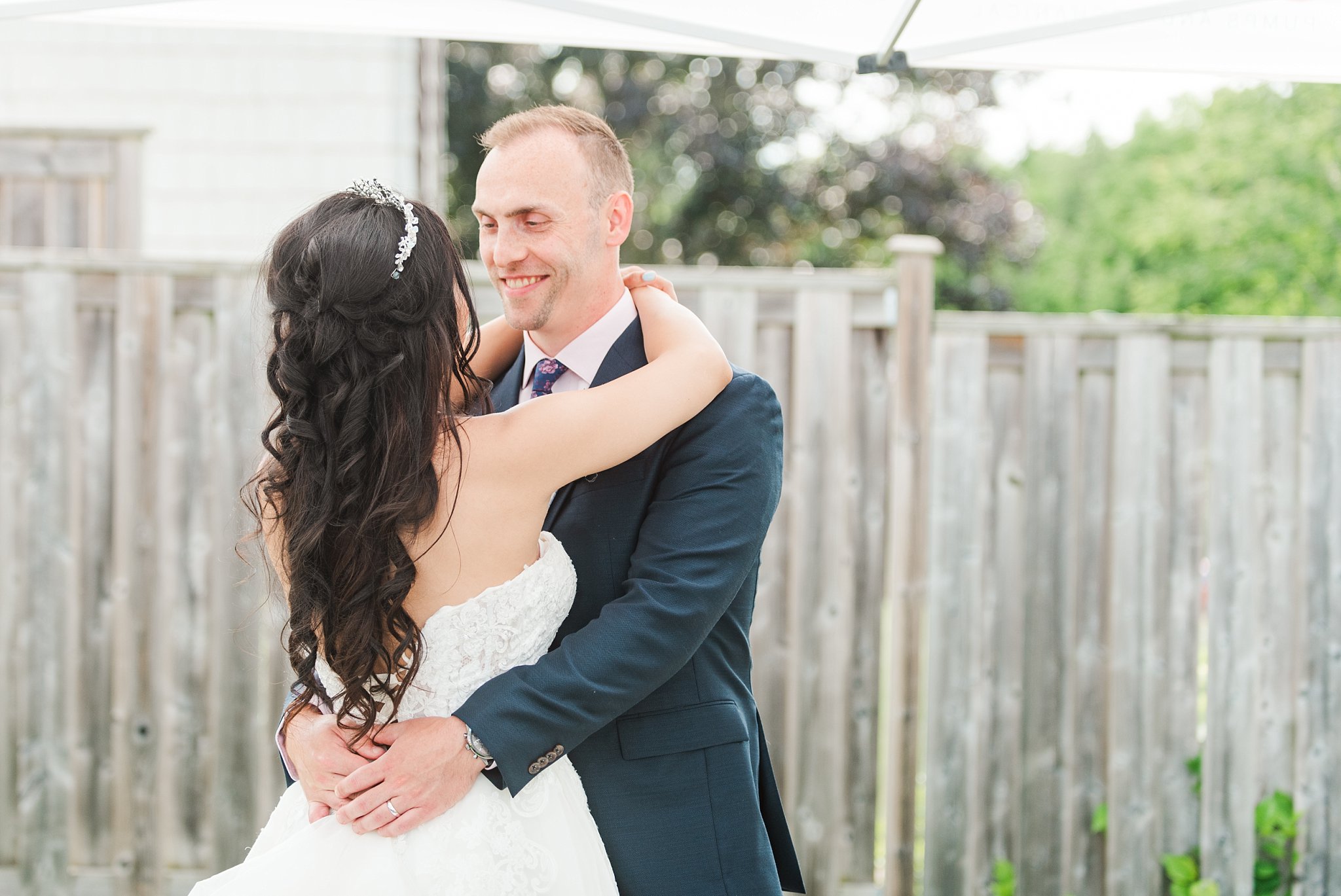 a groom smiles at his bride during their first dance  kelowna wedding photographer