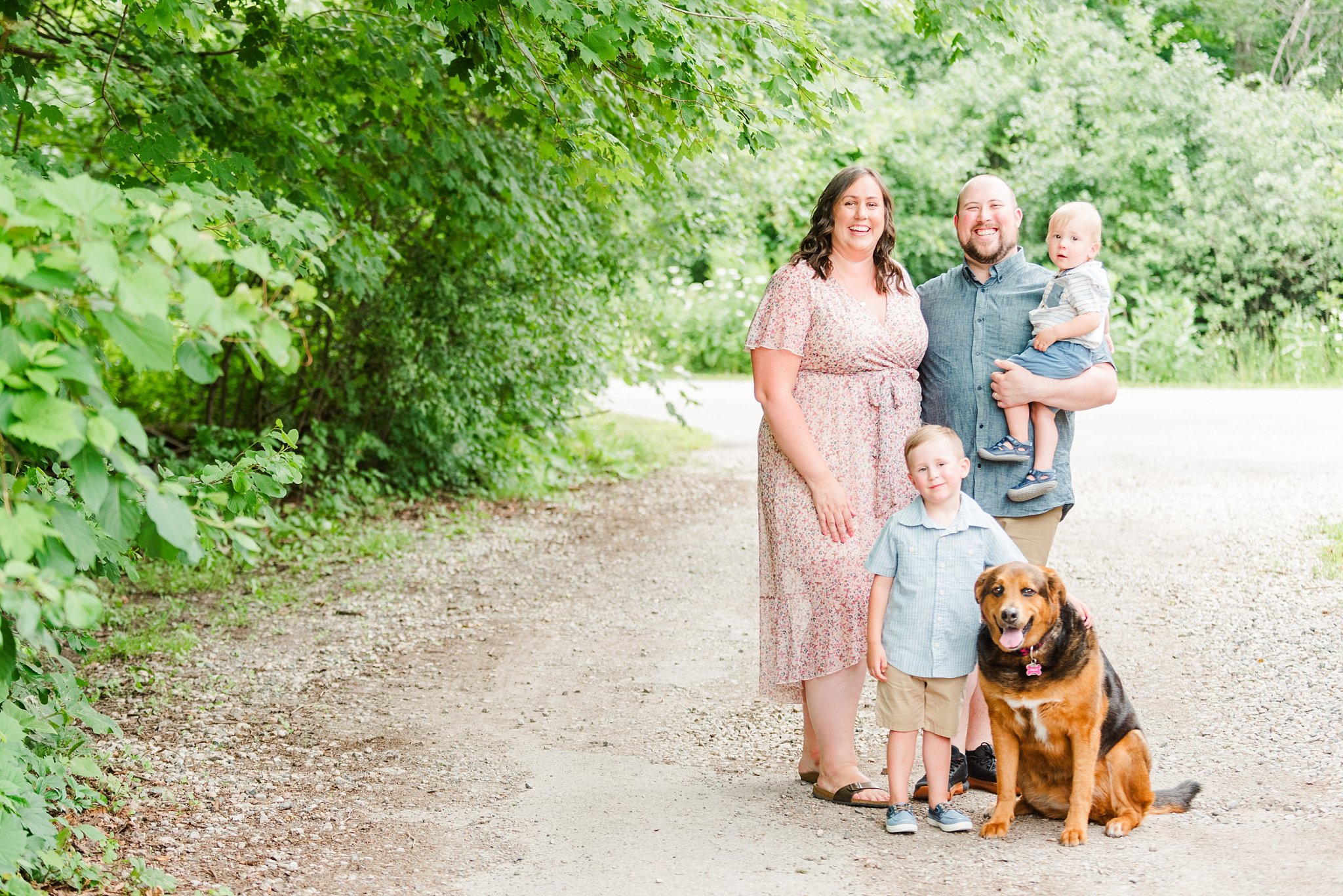 a family of four stands with their dog for family photos in london ontario