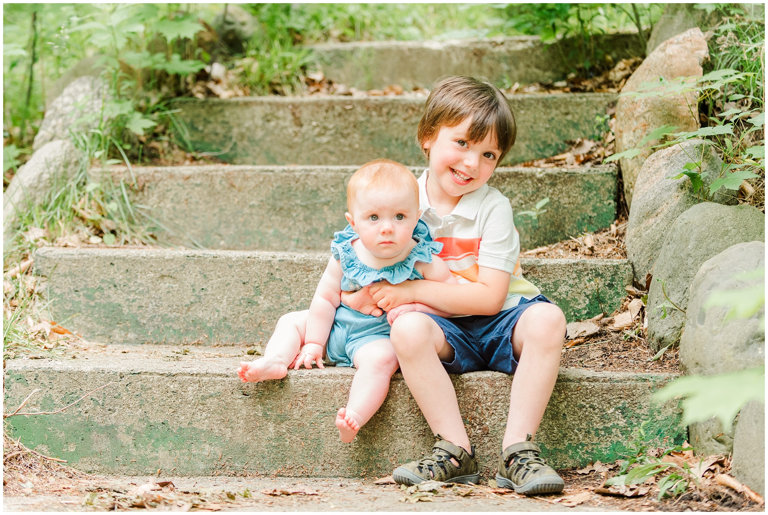 Two children sit on stone steps in Springbank Park by London Ontario Family Photographer Life is Beautiful Photography