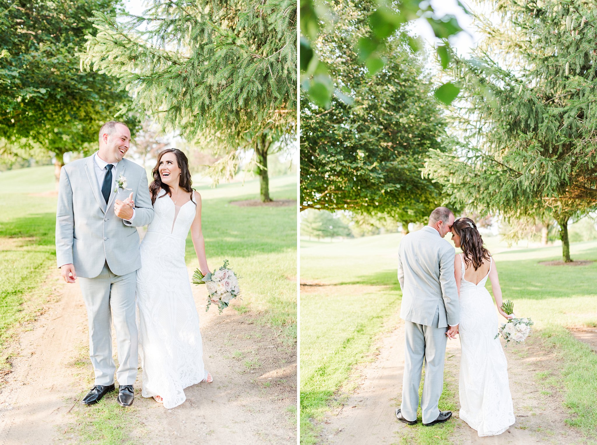 a bride and groom walk down a path bumping into one another and laughing