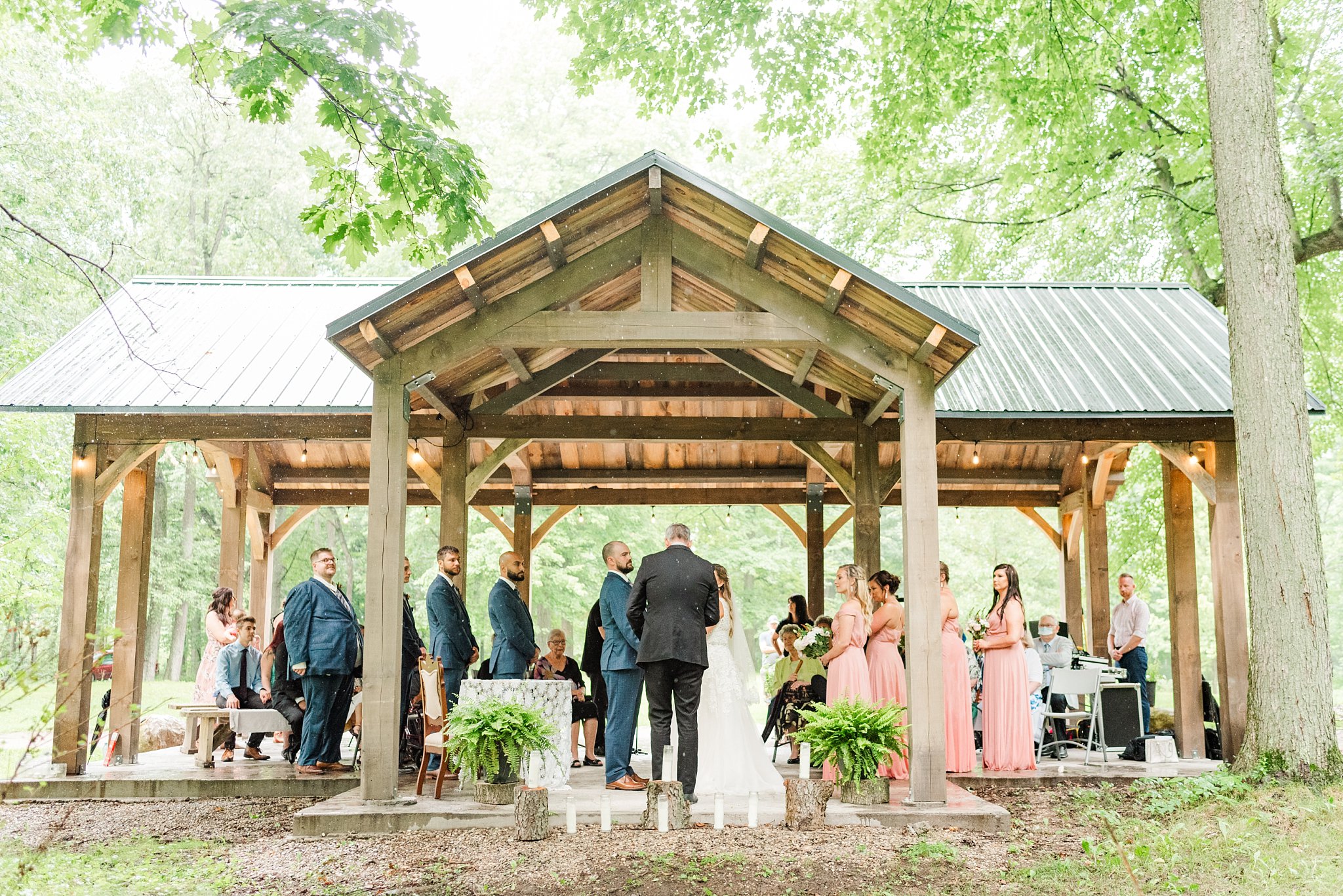 a view of the wedding ceremony from outside the pavilion at fernwood hills