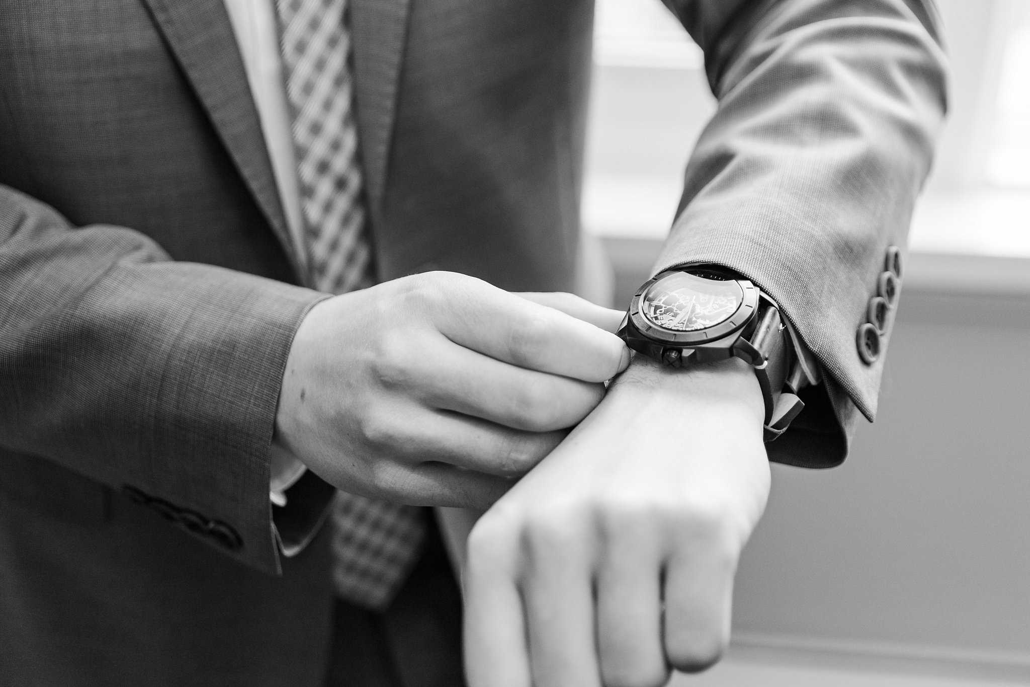 a groom puts on his watch