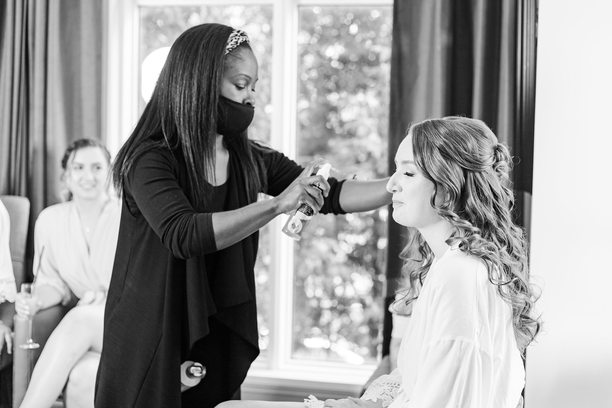 a makeup artist tends to a bride