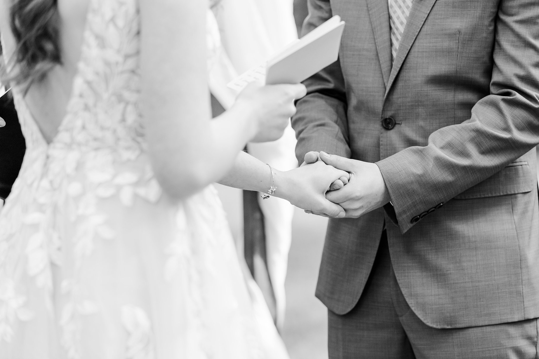 a bride and groom hold hands during their elm hurst inn wedding ceremony