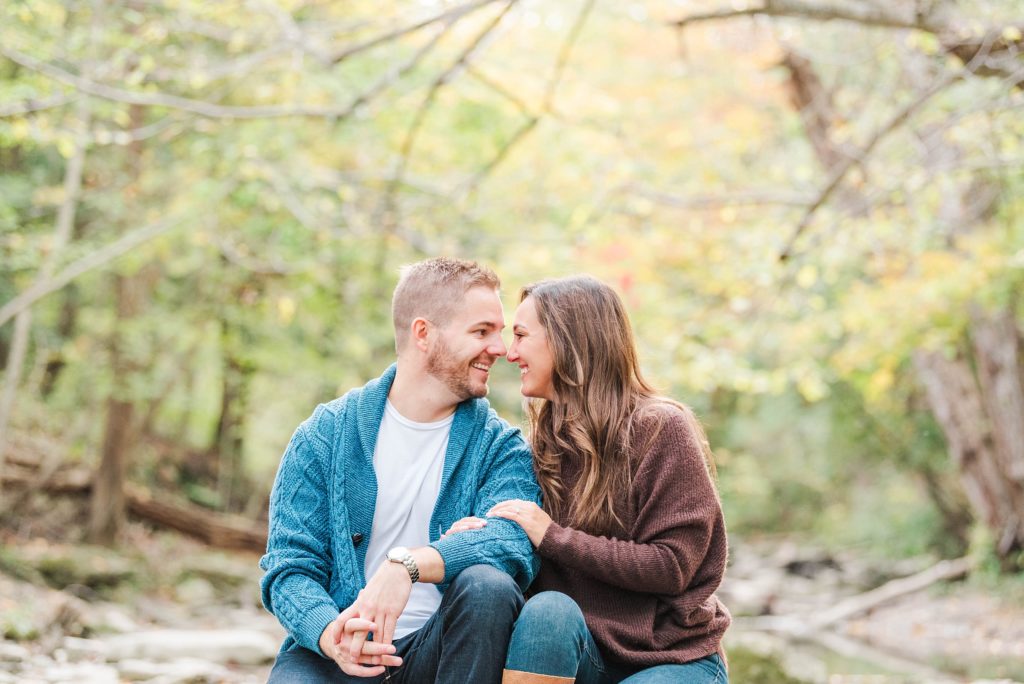 A man and woman smile at one another during an engagement session with Kelowna Wedding Photographer Life is Beautiful Photography