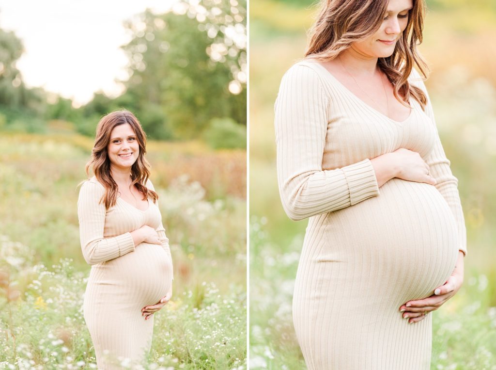 a pregnant woman stands with her hands on her baby bump and smiles at the camera for her maternity photos in euston park london ontario