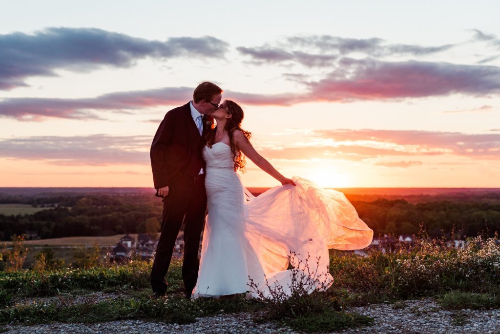 a bride and groom kiss during sunset at boler mountain