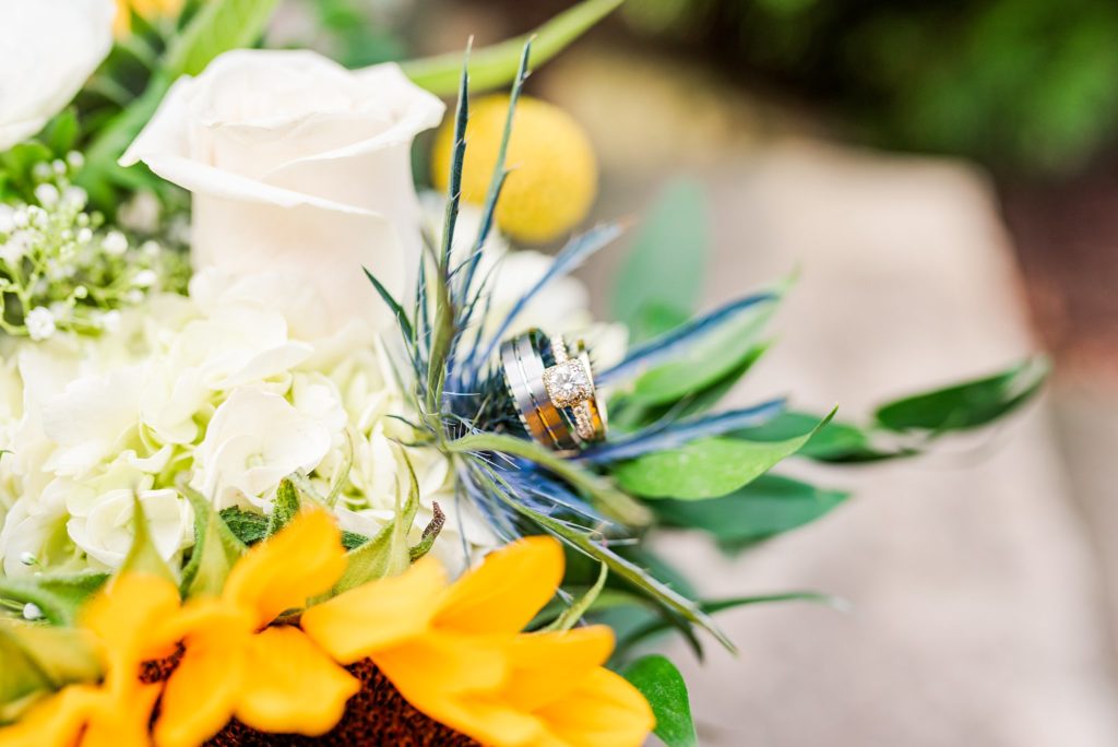wedding rings on a sunflower wedding bouquet