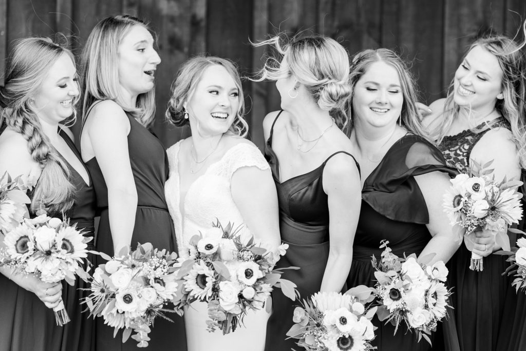 bridesmaids laughing together as their hair blows in the wind
