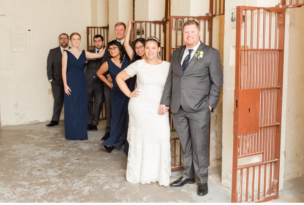 A wedding party stands in the old jail cells at The Old Courthouse London